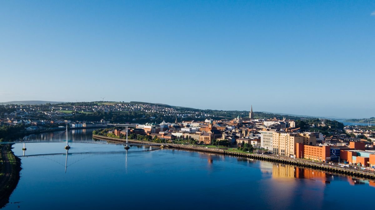 Sunny aerial view of Derry, the River Foyle and the Peace Bridge in summer