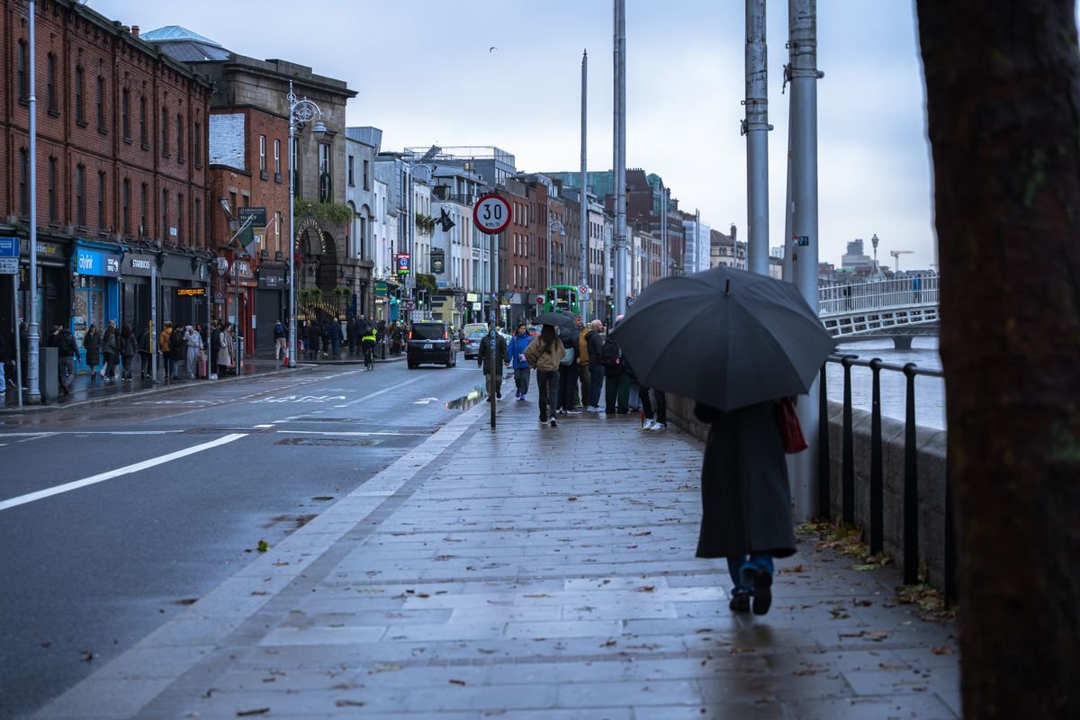 Rainy day on the Liffey quays in Dublin with an umbrella