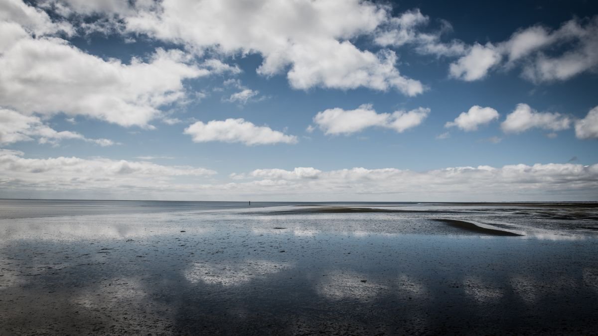 Low tide on a long flat Irish beach with water gone out