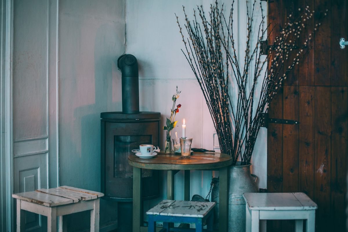 Cosy cottage interior with a wood stove and a coffee on the table