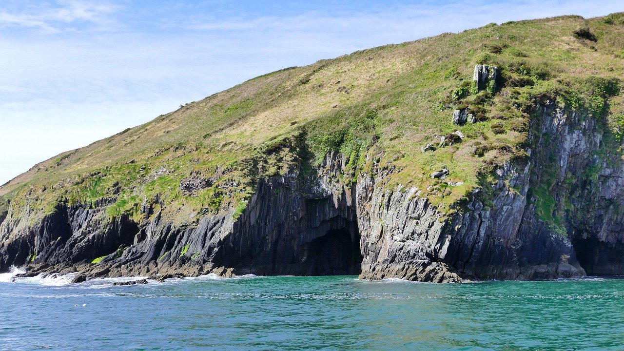 Rocky coves and green islets along the Ring of Kerry coast in southwest Ireland.