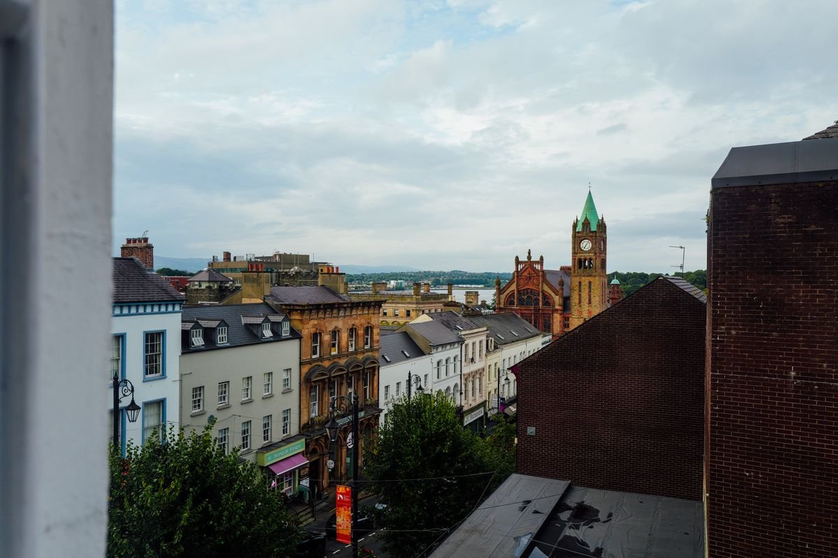 View over Derry rooftops to the Guildhall clock tower