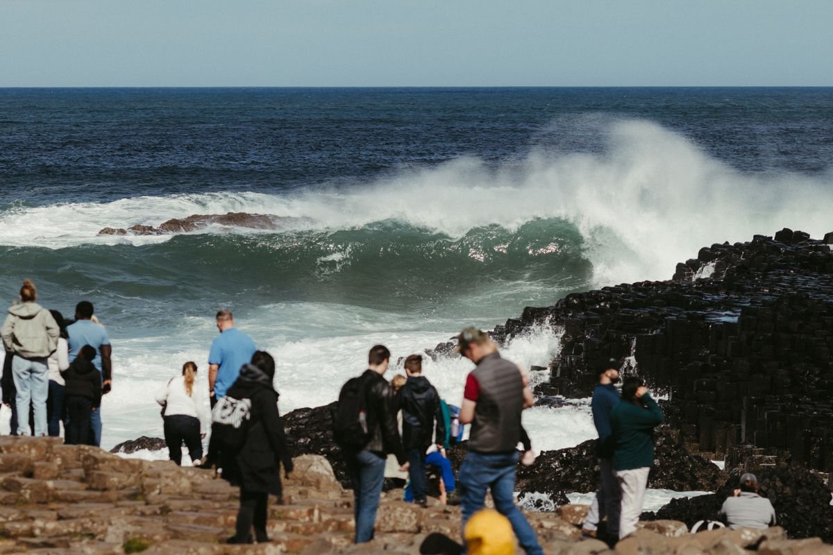 Crowds gather on the columns to watch the waves come in off the Atlantic.
