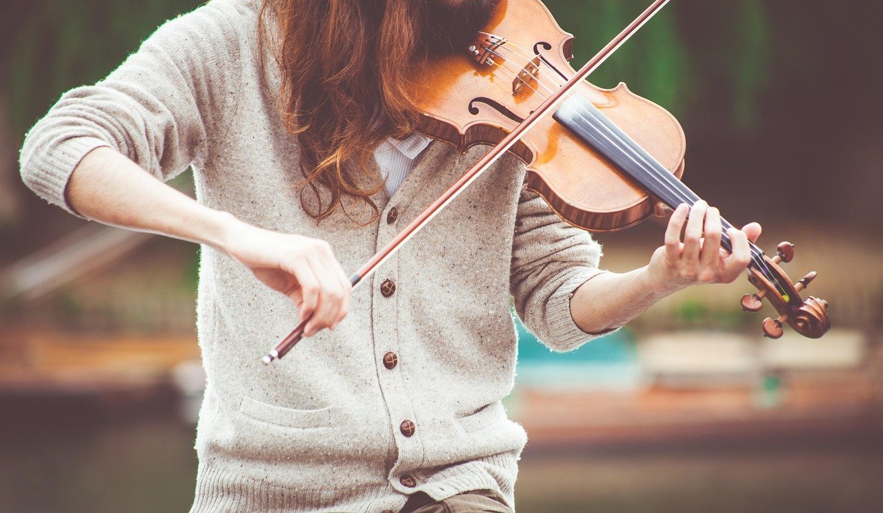 A musician playing the fiddle during a live traditional Irish music session