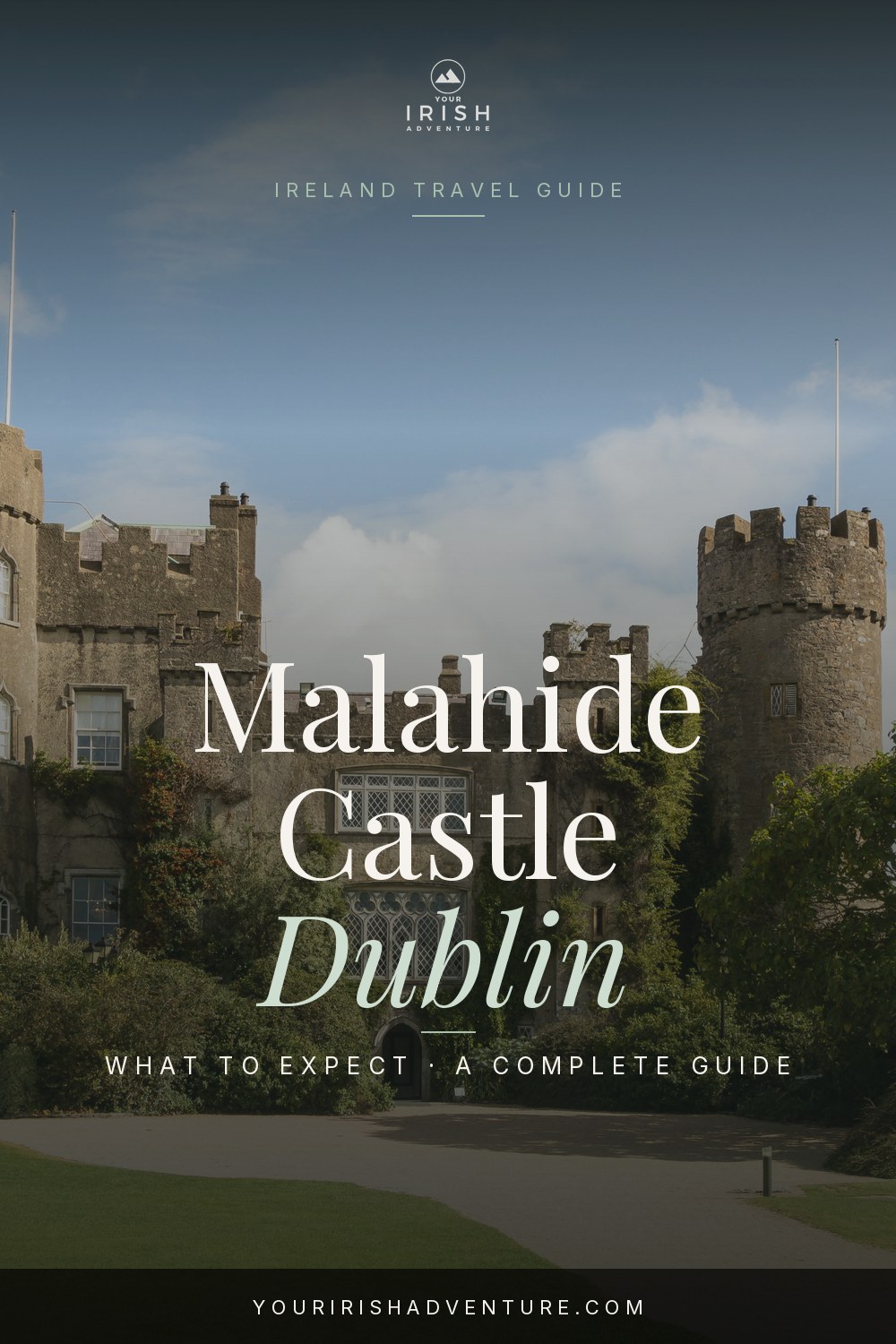 Stone facade of Malahide Castle in Dublin with green lawns and turrets