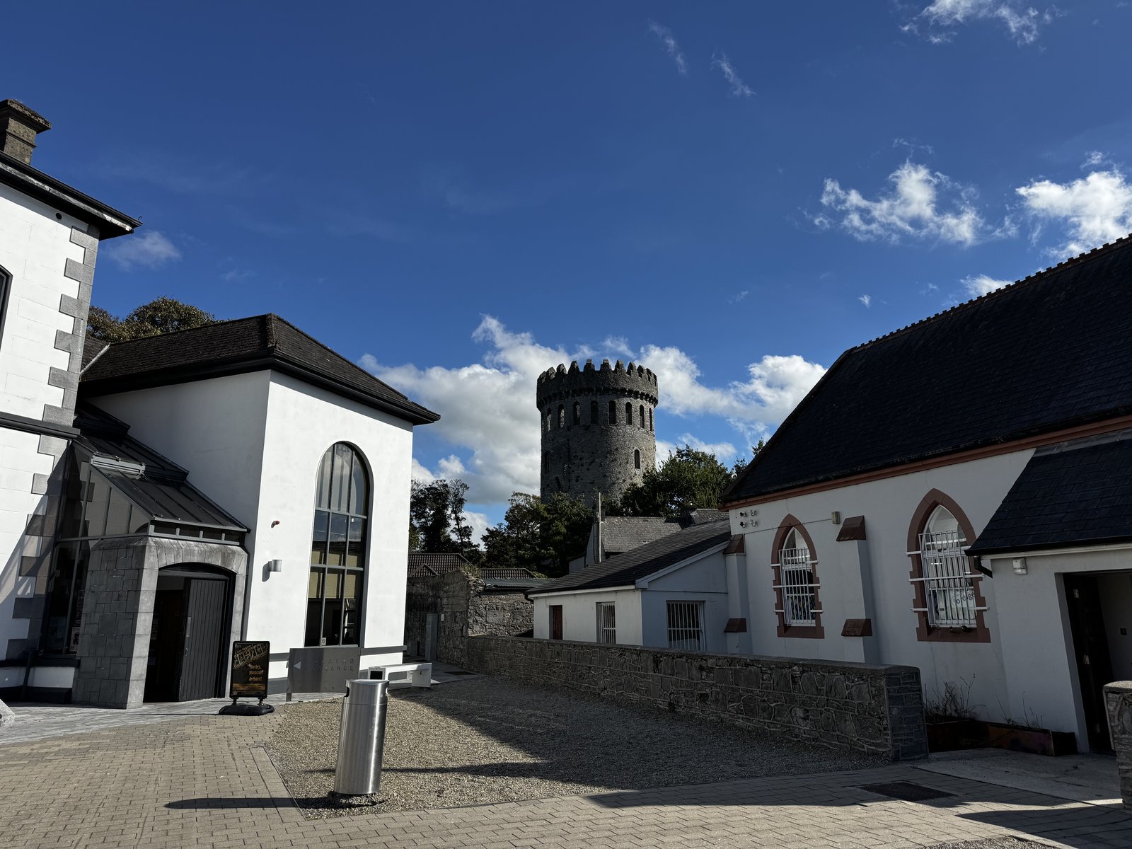 Round tower of Nenagh Castle rising above the town under blue sky