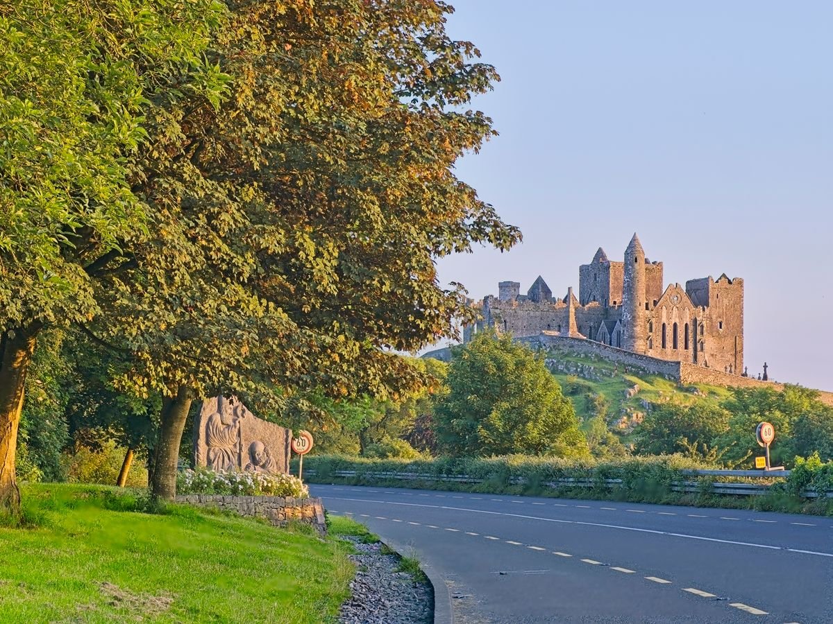 The Rock of Cashel seen from the road into town in golden evening light
