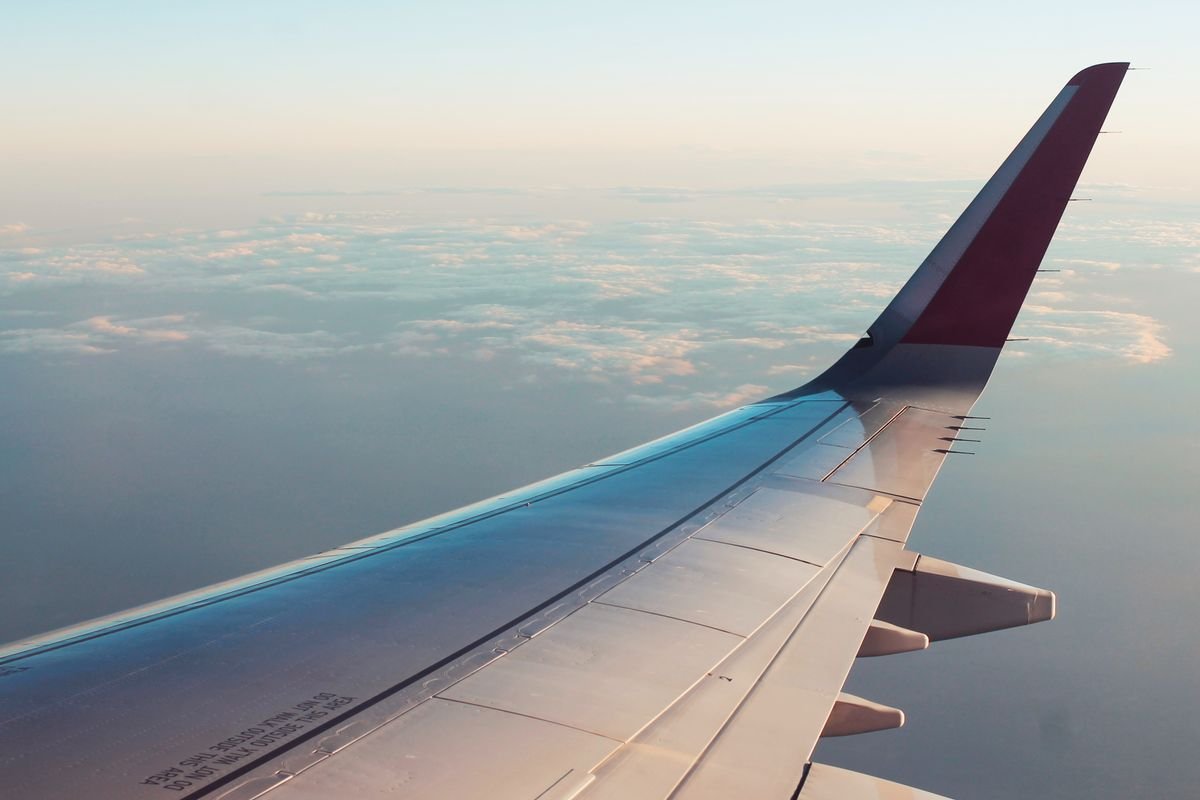View of an aircraft wing above the clouds