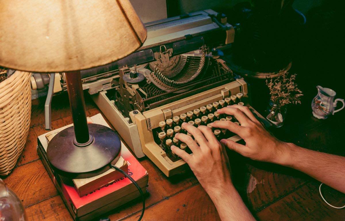 Vintage typewriter with hands typing