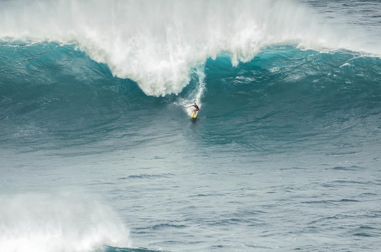 Surfer dropping into a huge Atlantic wave
