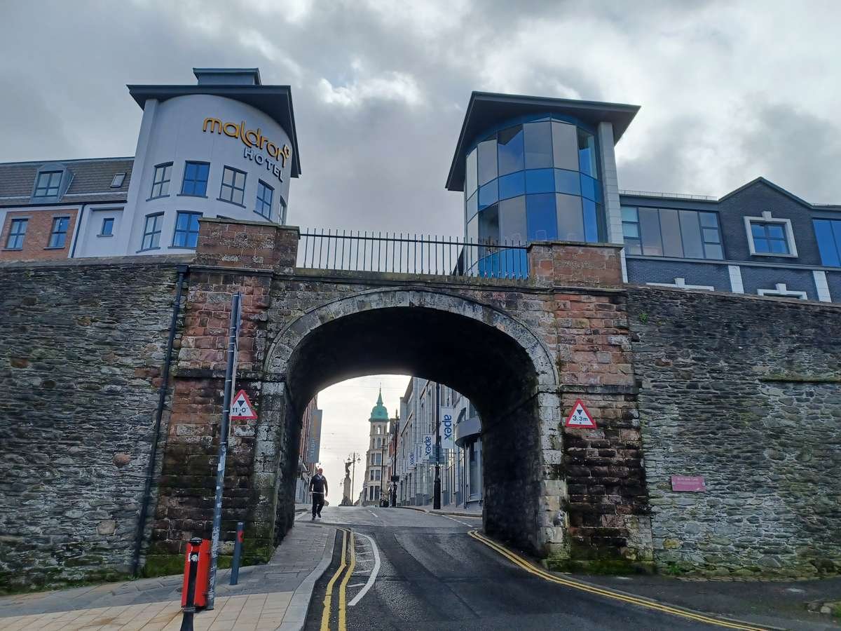 The stone archway of Butcher Gate cut through the historic Derry city walls