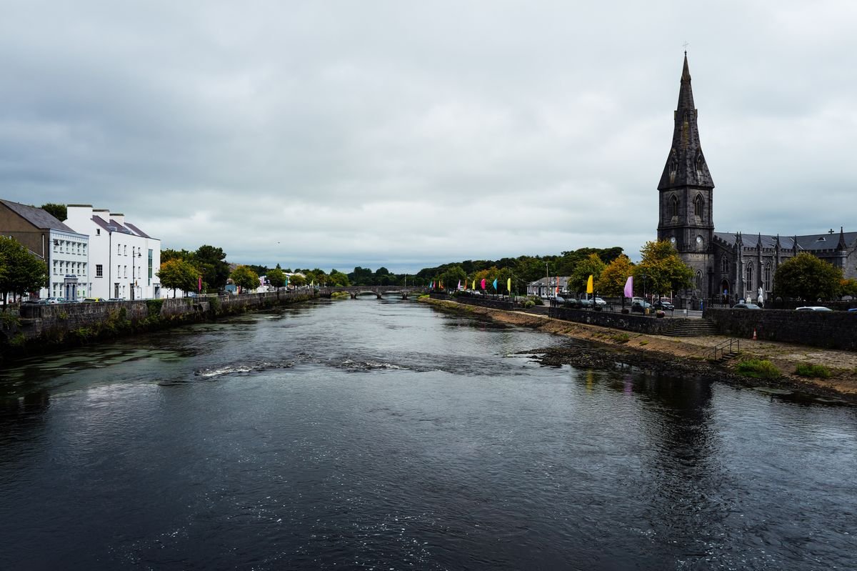 Riverside town with a church spire and quayside, Enniskillen area