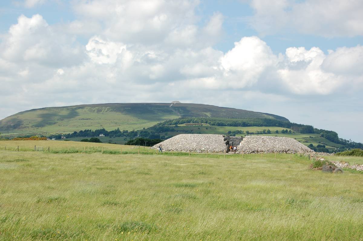 Carrowmore megalithic tomb with the flat-topped Knocknarea mountain and its cairn on the skyline