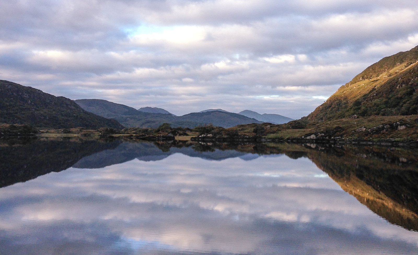 Lakes and mountains reflected in still water along the Ring of Kerry near Killarney