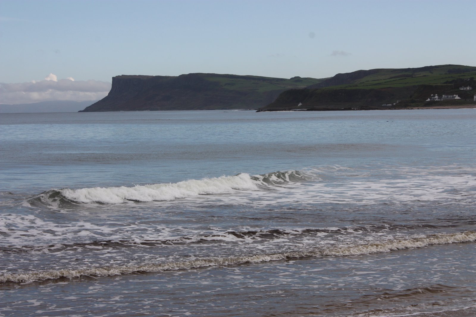 Waves on Ballycastle Beach with the Fairhead cliffs across the bay