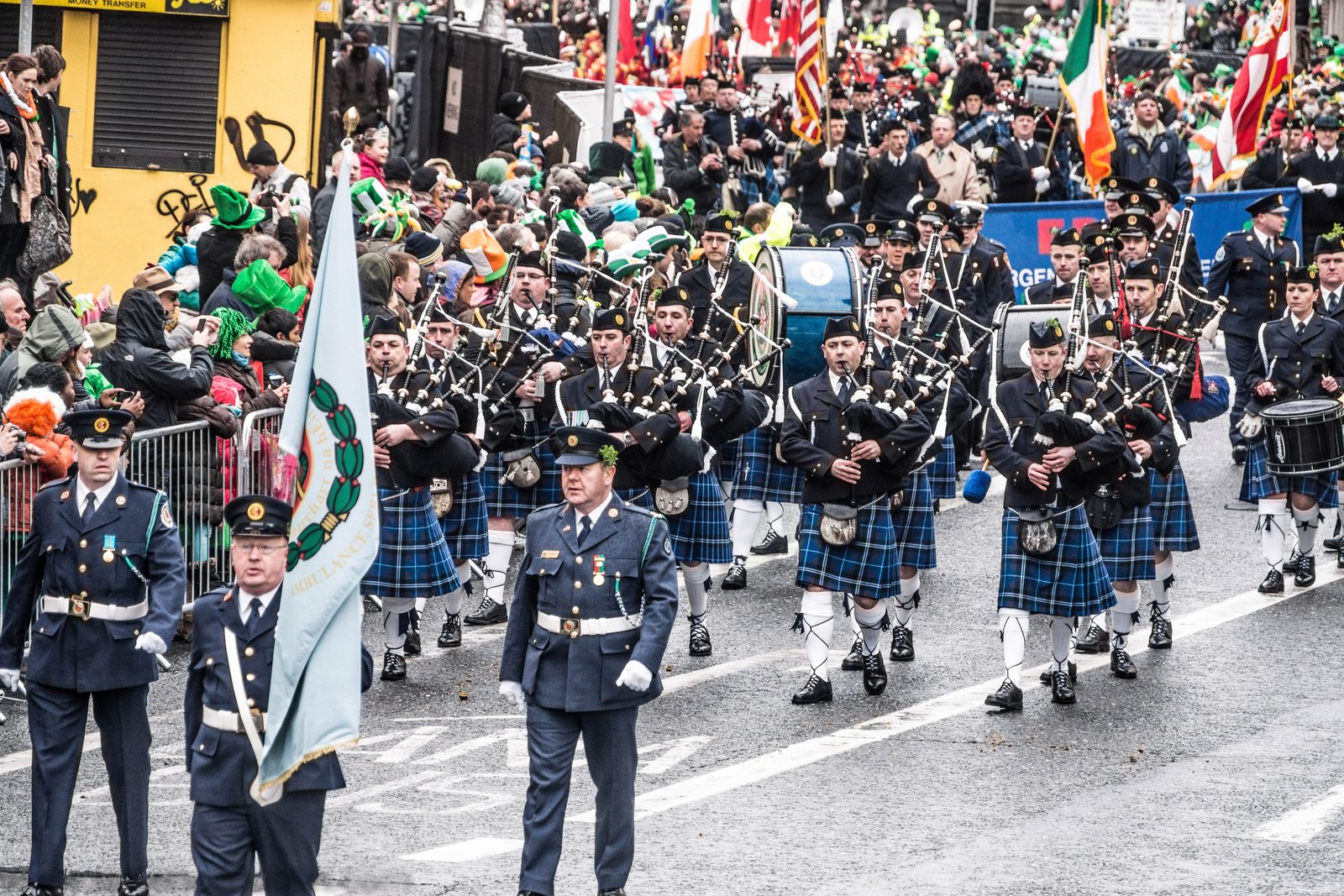 A Garda pipe band marching in the Dublin St Patricks Day parade with Irish flags