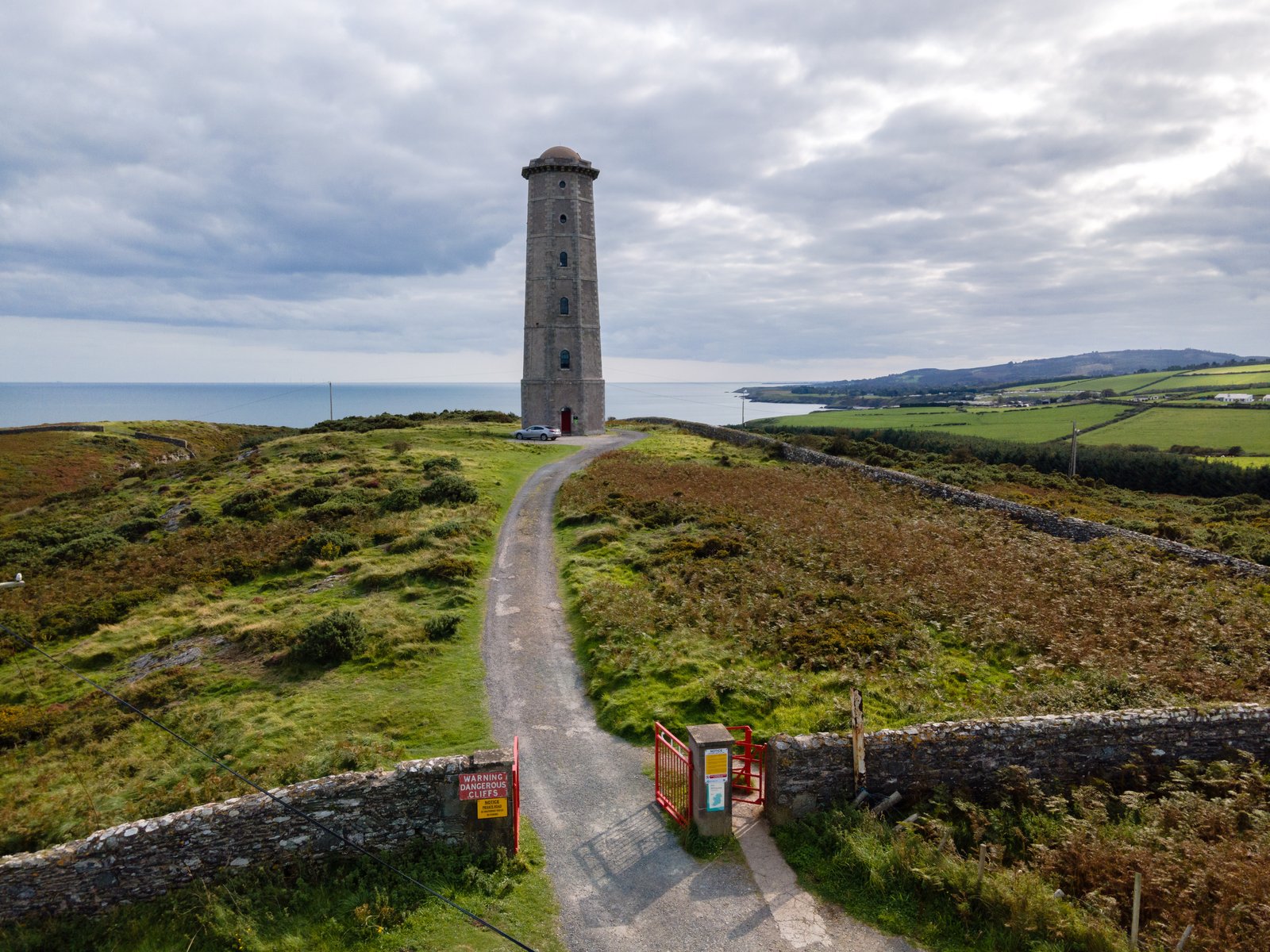 Wicklow Head Lighthouse octagonal stone tower on a green headland