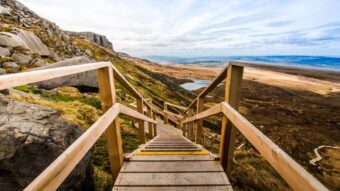 Wooden boardwalk and staircase climbing Cuilcagh Mountain above the blanket bog in County Fermanagh