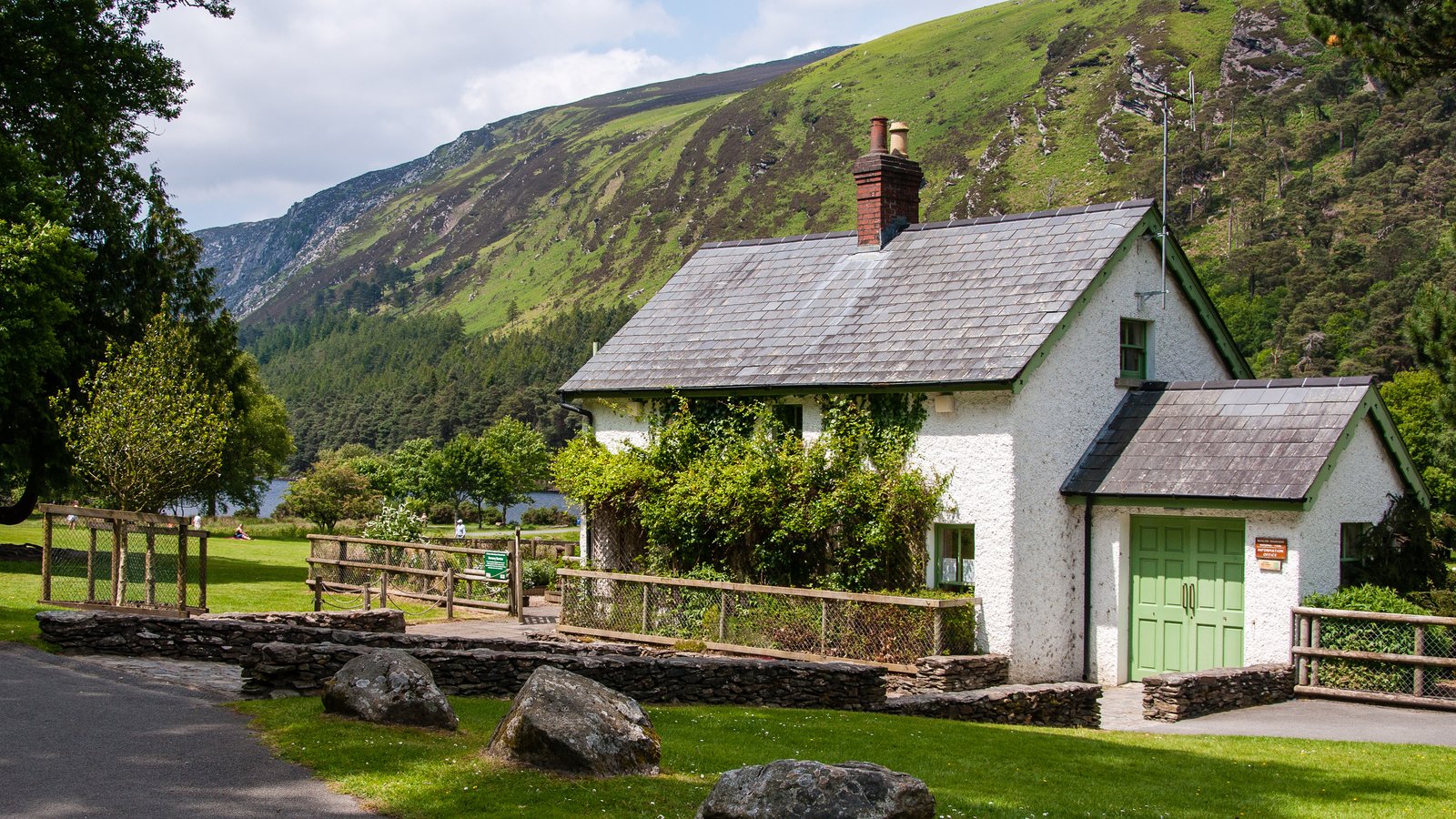 White cottage below green hills at Glendalough in Wicklow