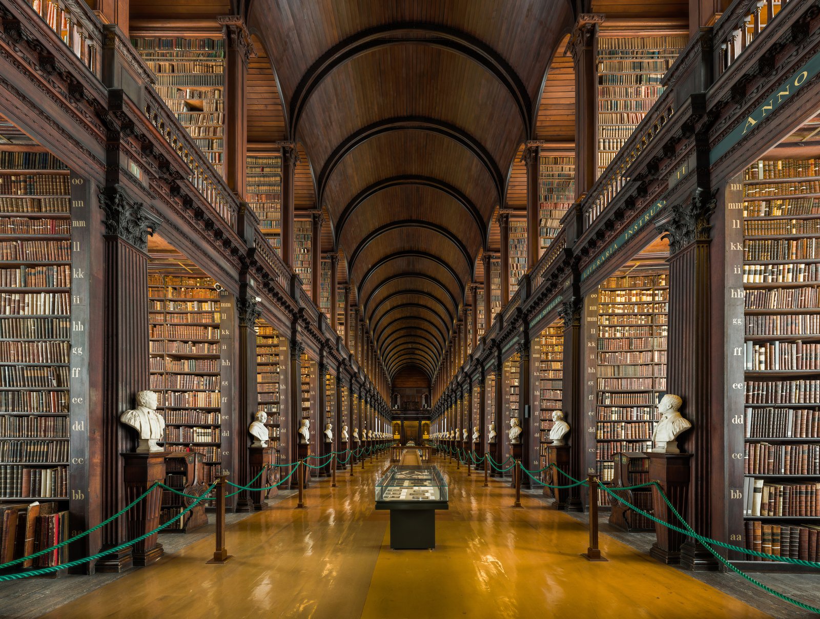 The barrel-vaulted Long Room library at Trinity College Dublin lined with old books and marble busts