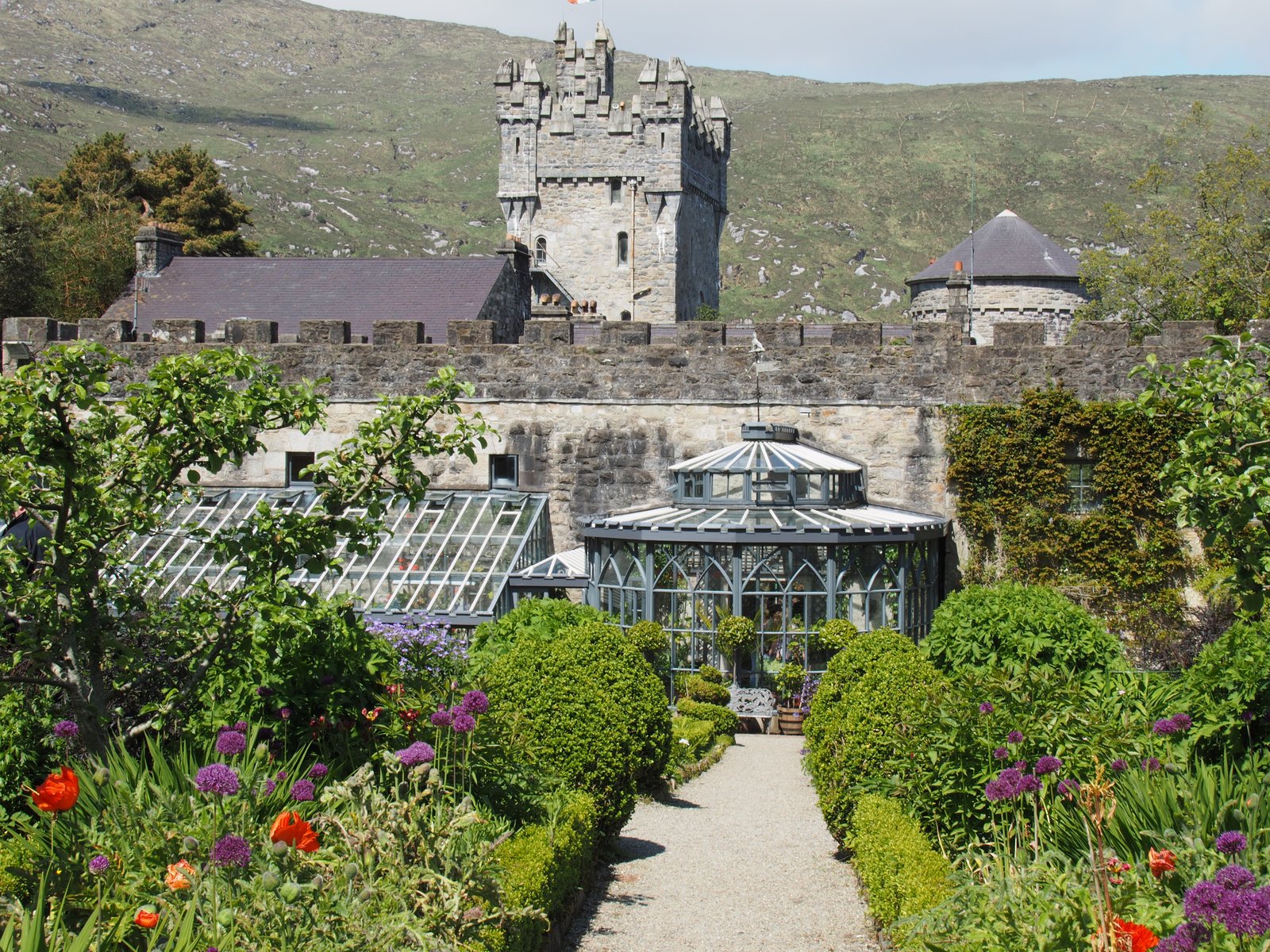 Glenveagh Castle behind the walled garden and glasshouse in Glenveagh National Park, County Donegal.