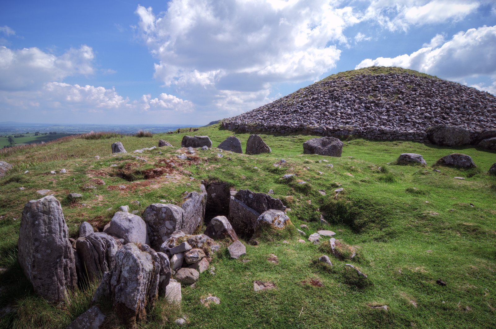 The Cairn T passage tomb mound with kerbstones on the grassy summit at Loughcrew