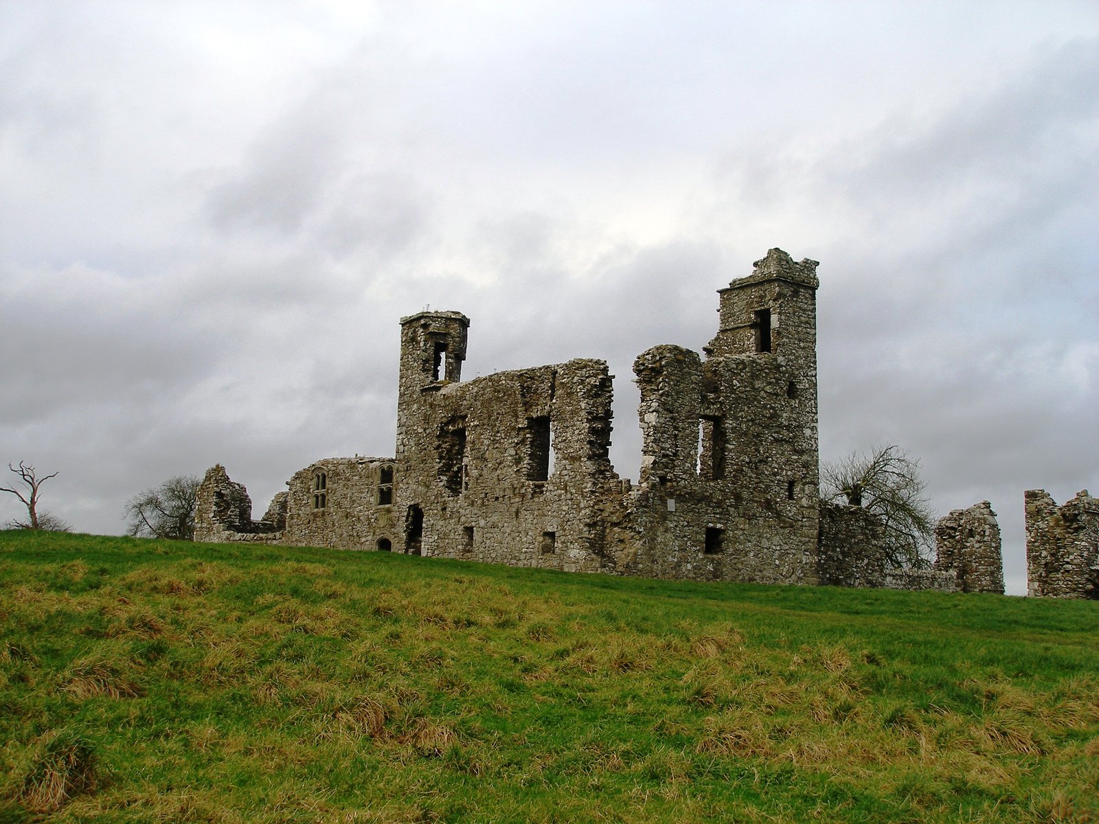 The stone friary and college ruins crowning the grassy Hill of Slane