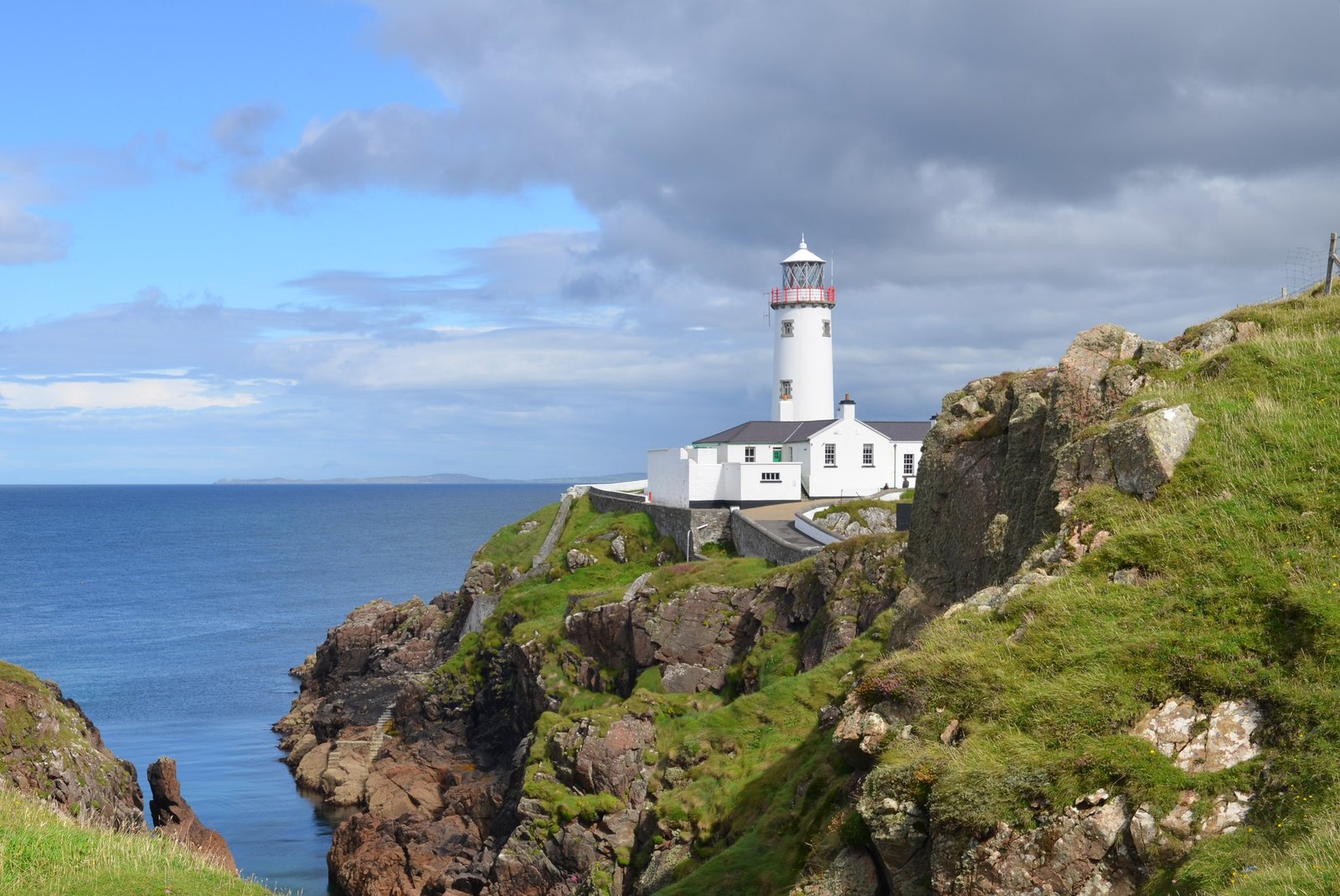 White Fanad Head Lighthouse on the cliff edge above the sea in County Donegal