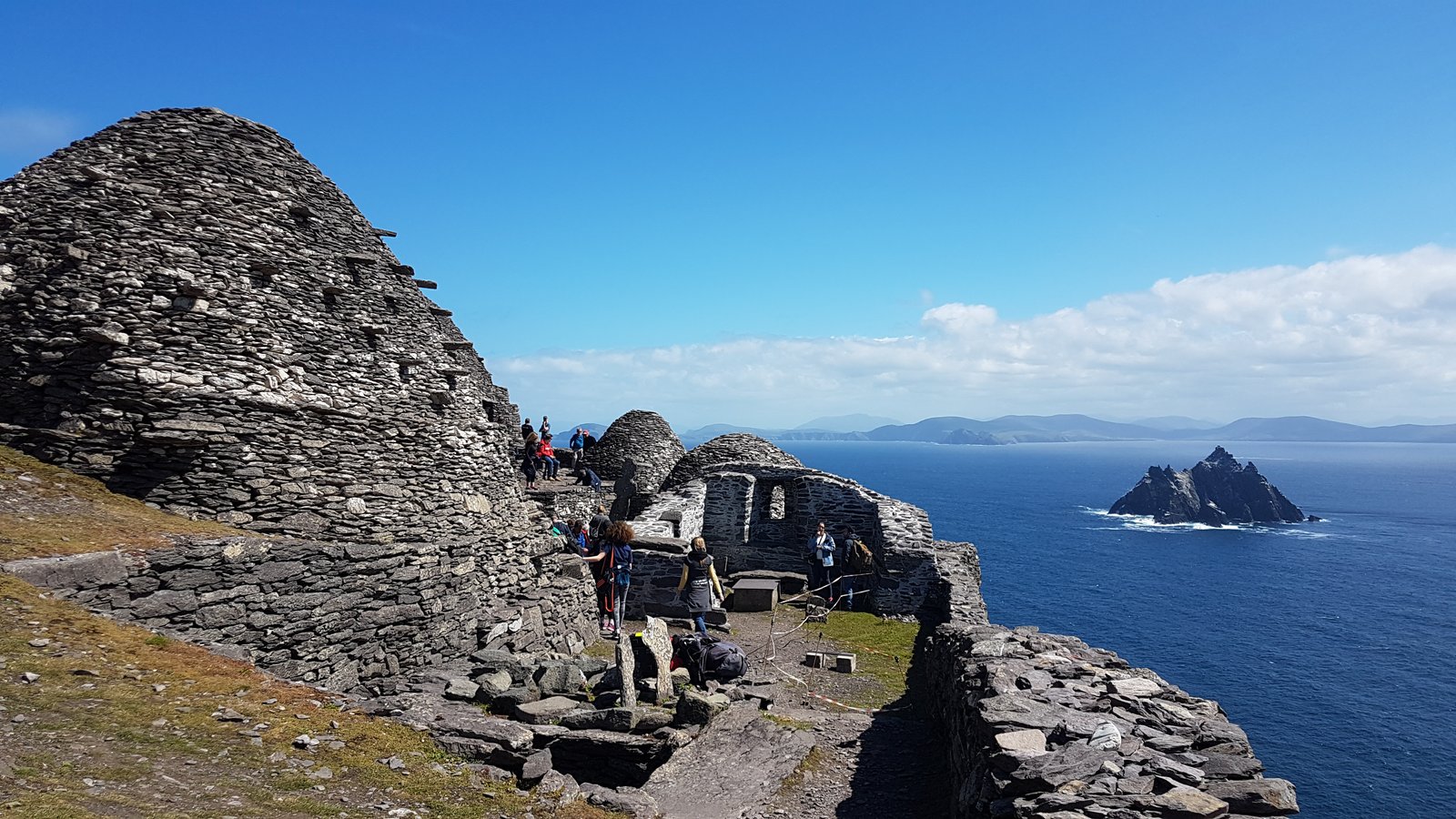 Stone beehive monastic huts on Skellig Michael with Little Skellig island in the distance