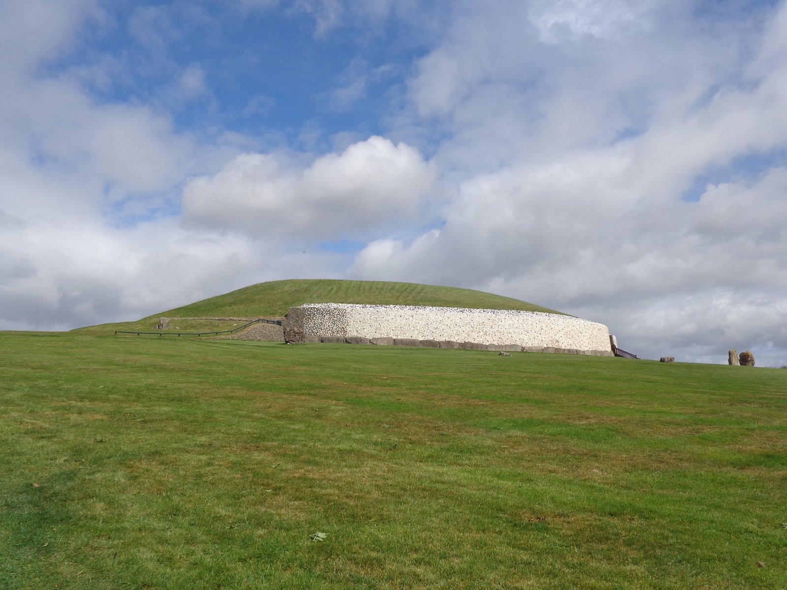 The grass-topped mound and white quartz wall of Newgrange passage tomb in County Meath