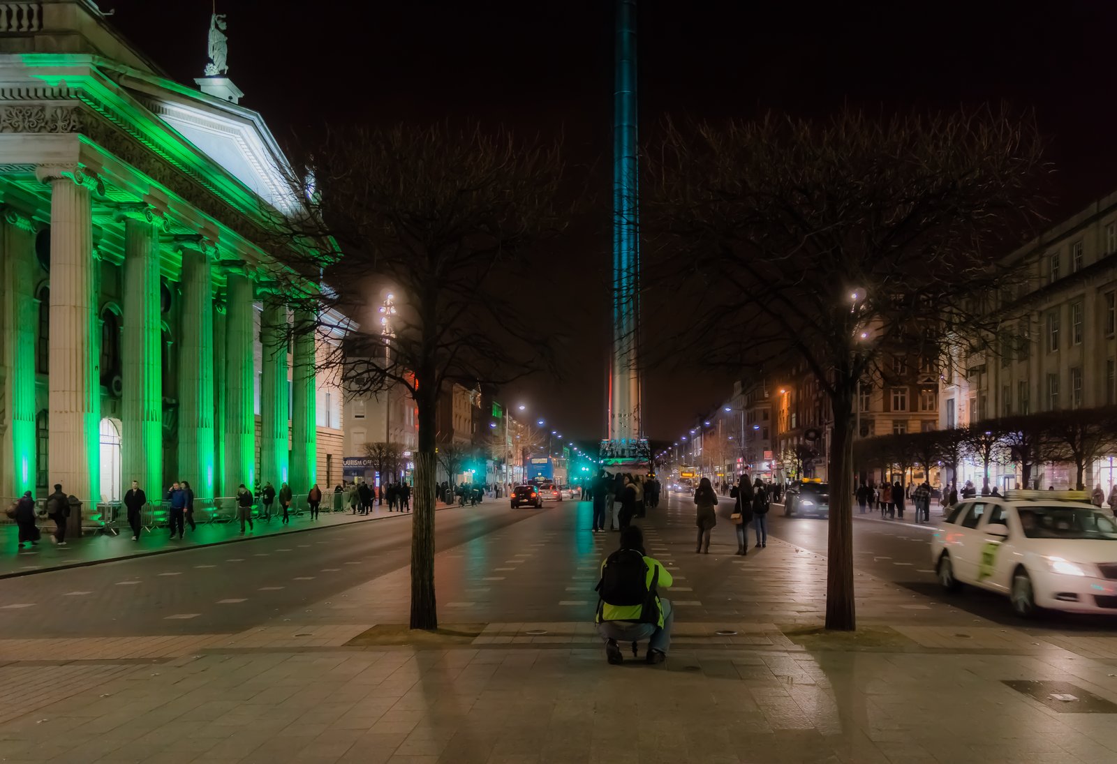The GPO on OConnell Street in Dublin lit up green at night with the Spire behind