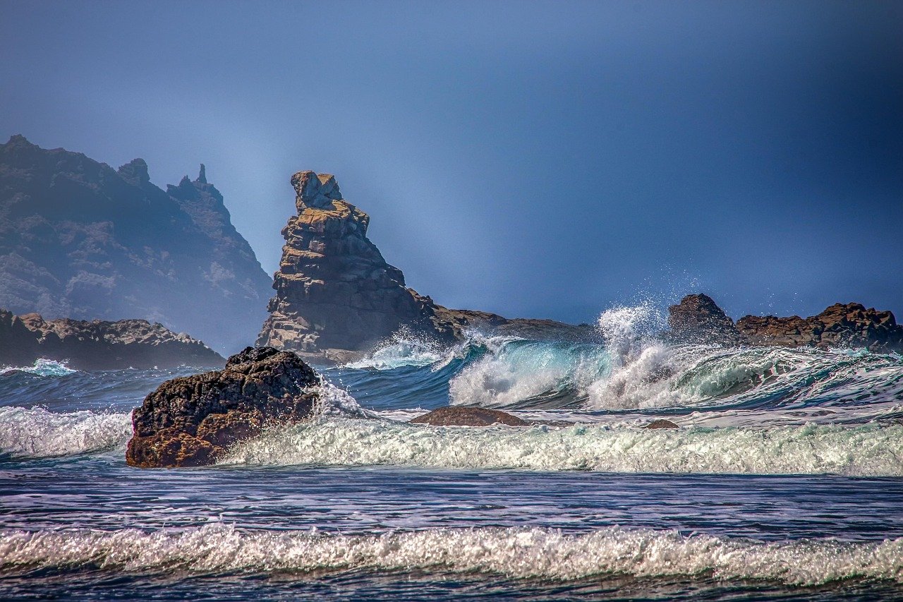 Waves crashing over rocky sea stacks on the Irish coast