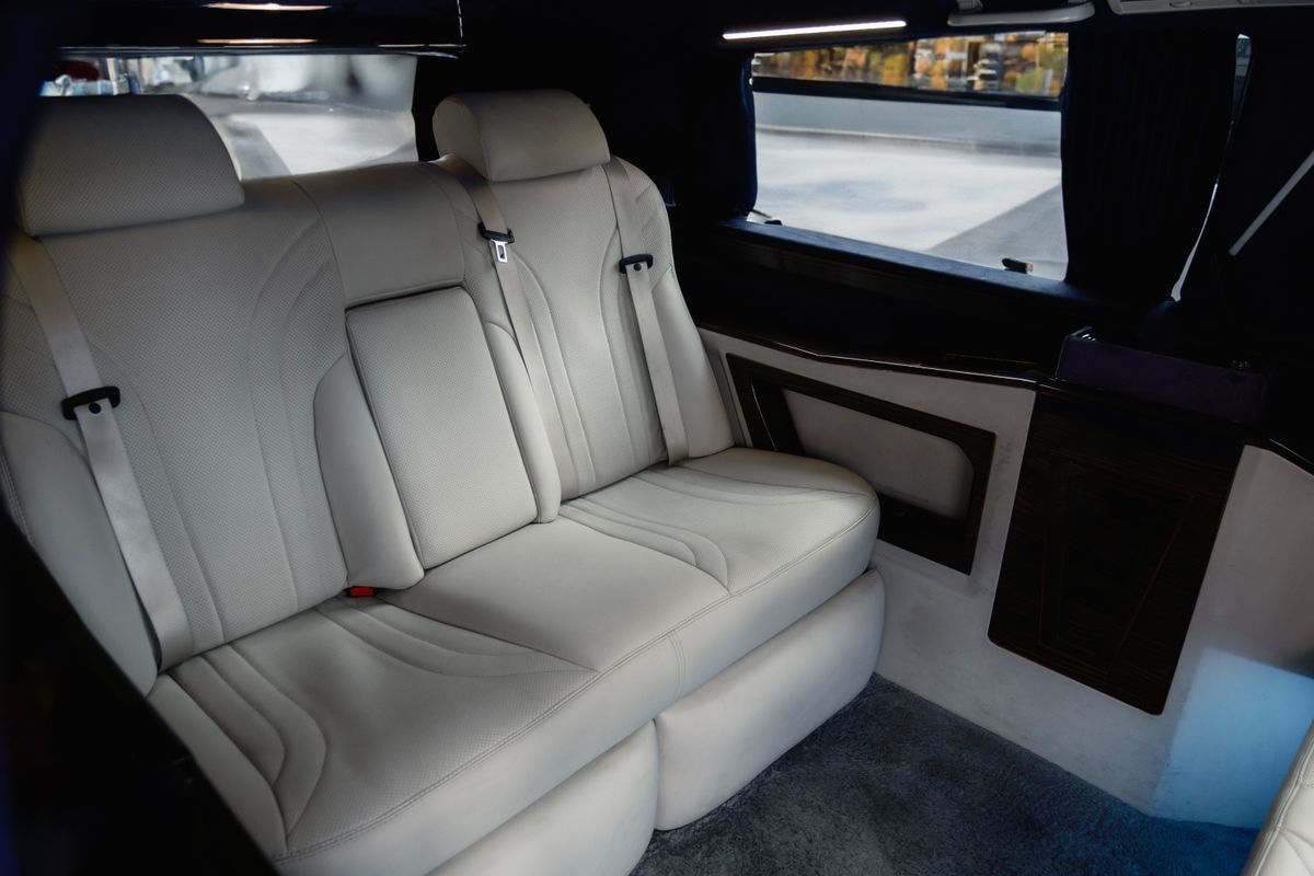 Cream leather rear seats inside a luxury chauffeured car