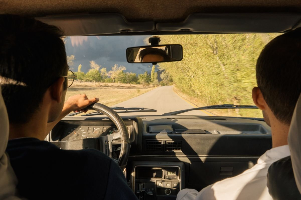 View through a windscreen driving along a quiet country road