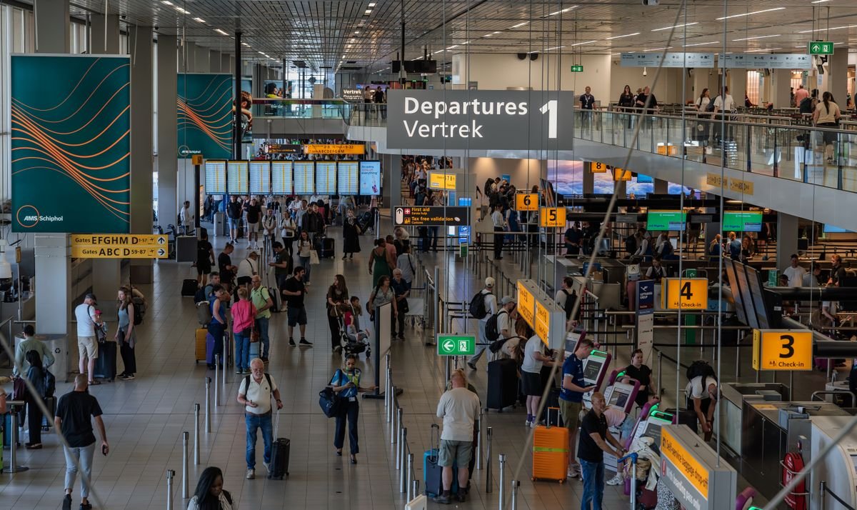 Travelers in an airport departures hall