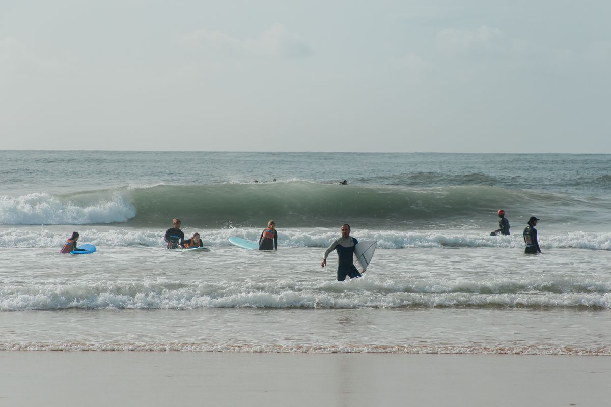 Beginner surfers in the whitewater on a summer beach