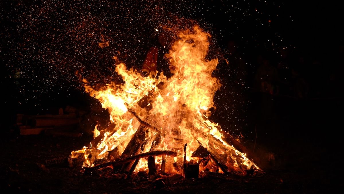 Roaring bonfire with sparks at night on Halloween