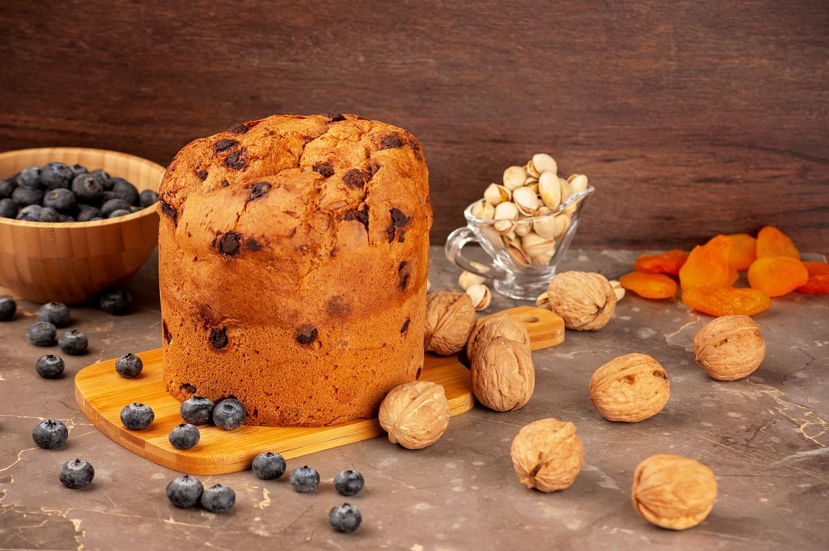 Irish barmbrack fruit loaf on a board with nuts and berries