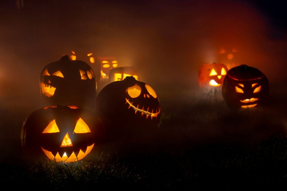 Carved jack o lanterns glowing in the dark