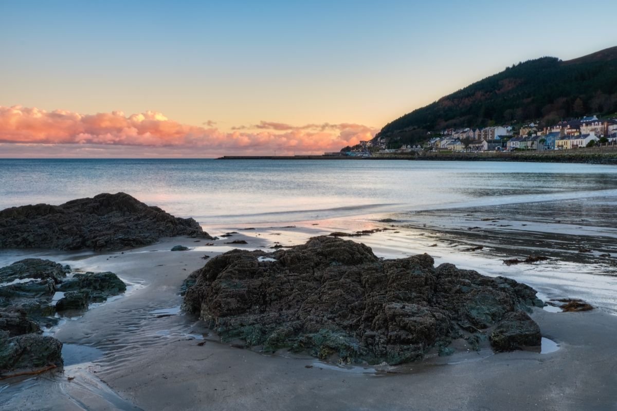 The beach at Newcastle in County Down with the Mourne Mountains rising behind the town