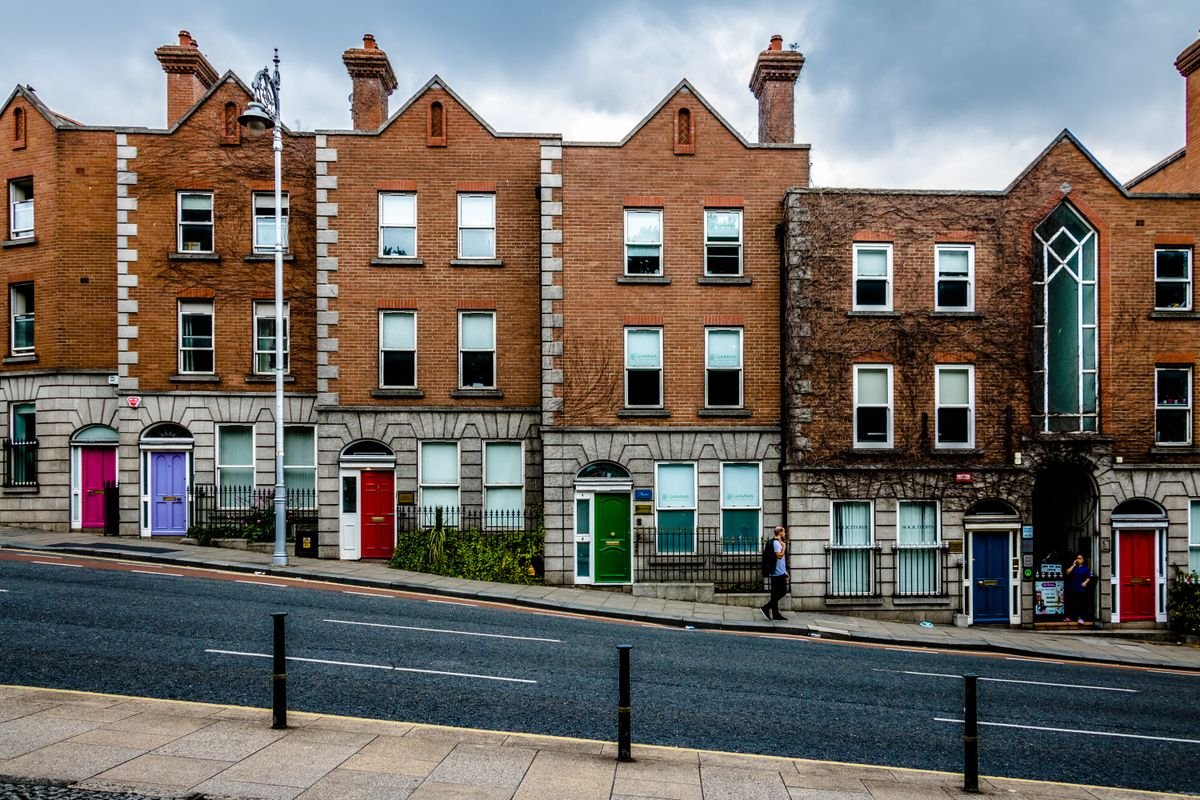 A row of Dublin Georgian townhouses with brightly painted front doors