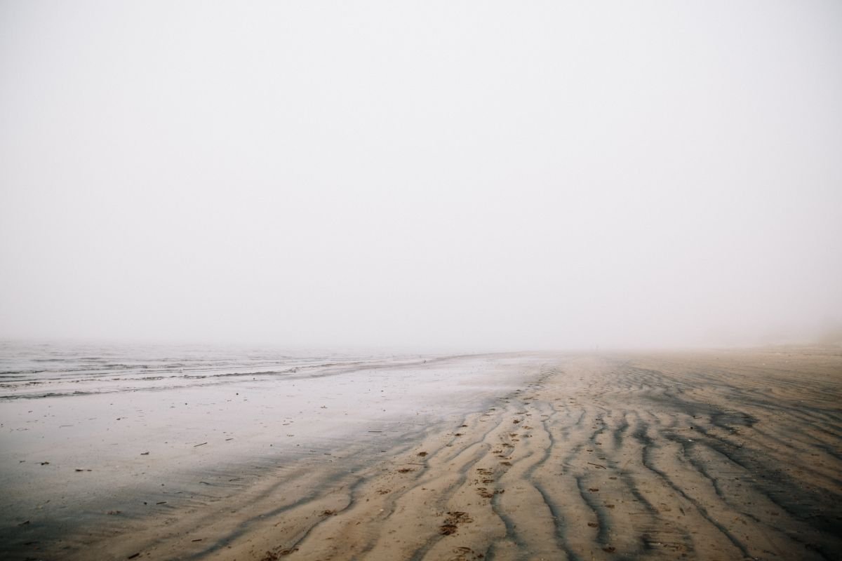 A deserted foggy beach in the quiet season