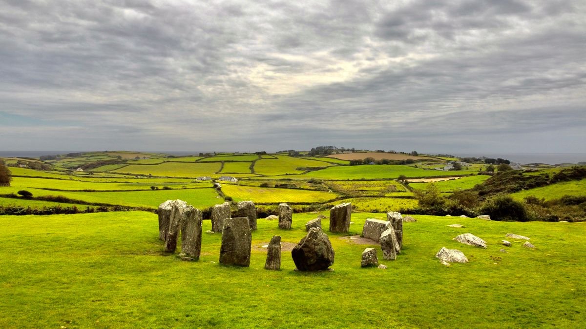 ring of standing stones in a green Irish field