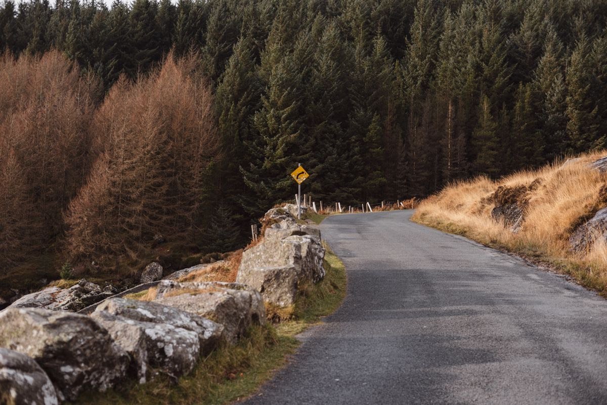 Narrow rural road with stone walls in Ireland