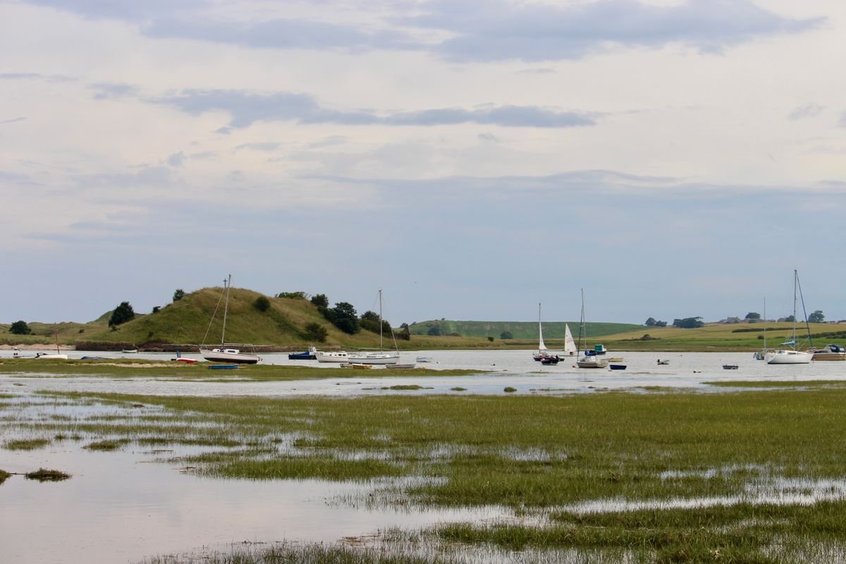 Calm estuary water with small sailboats near the Hook Peninsula in County Wexford