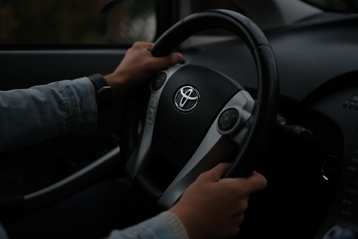 Driver-guide hands on the steering wheel of a private tour vehicle