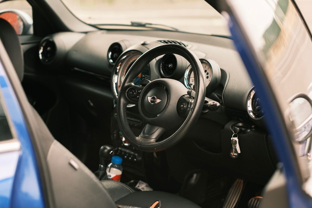 Right-hand-drive rental car interior with keys in the ignition