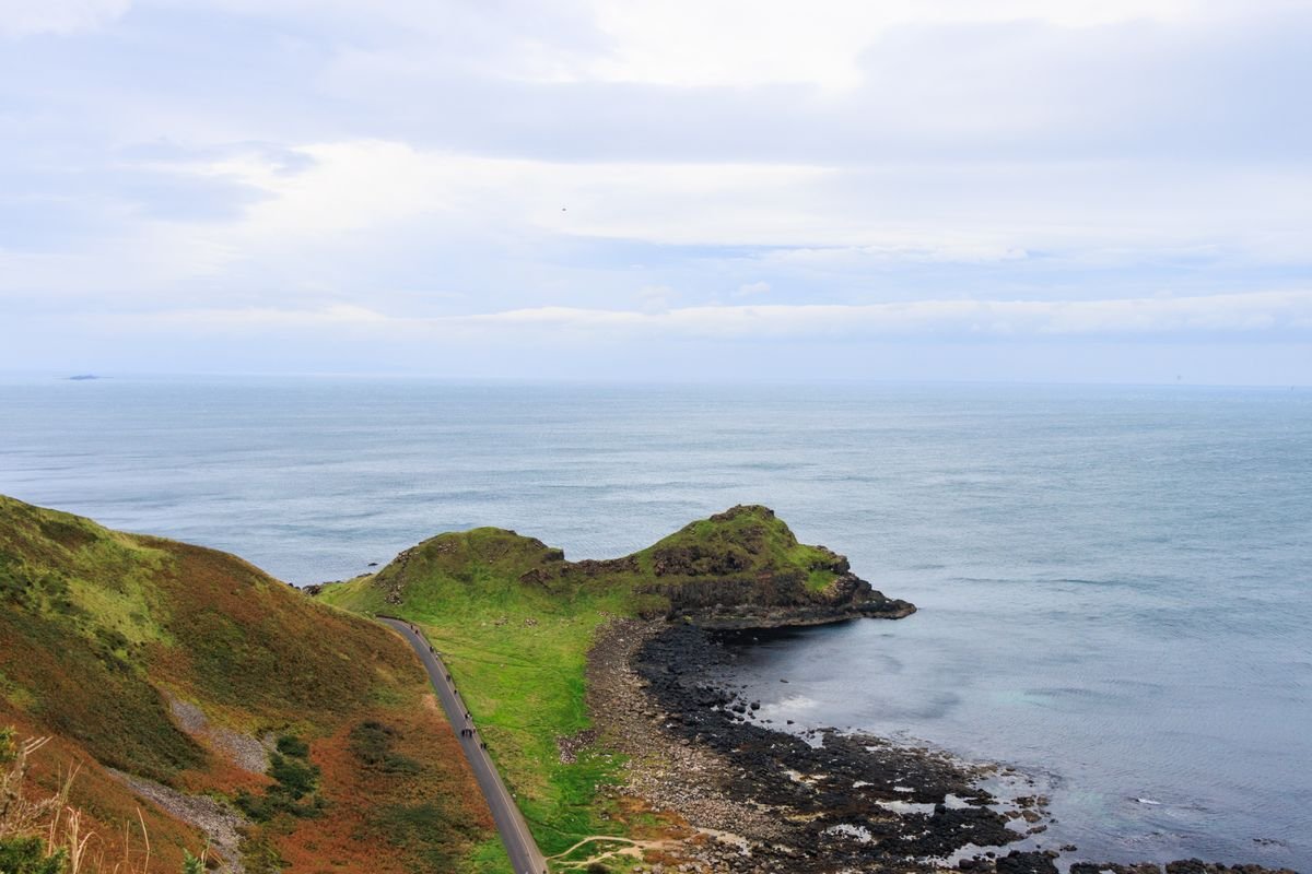 A wide seasonal view of the Causeway Coast headland