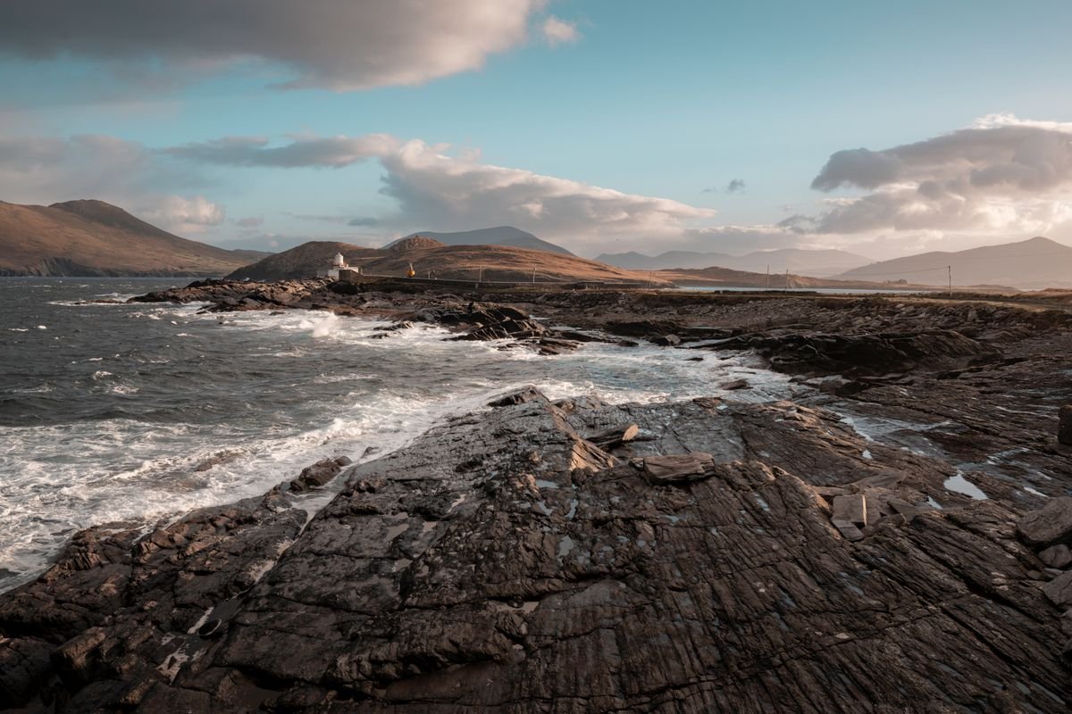 Irish coast at golden hour with mountains and sea