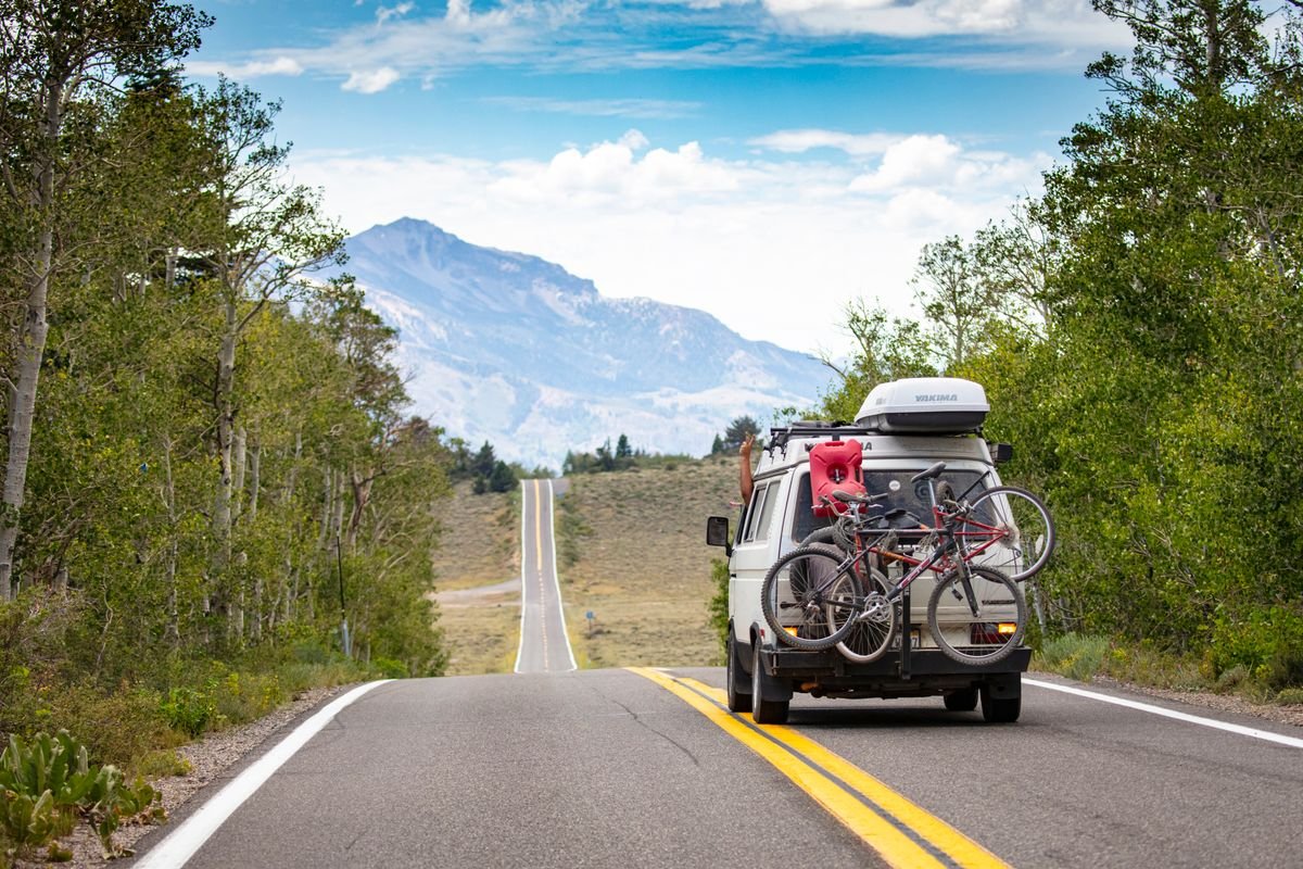 Bikes loaded on a van rack being shuttled to the route